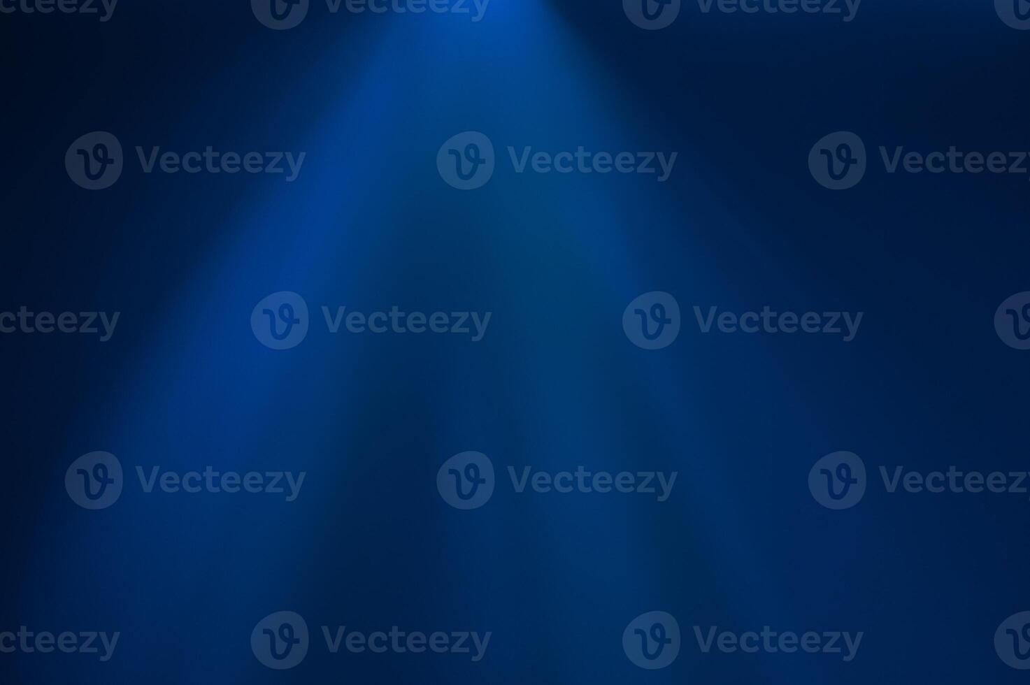 A beam of blue light cutting through the dark background photo
