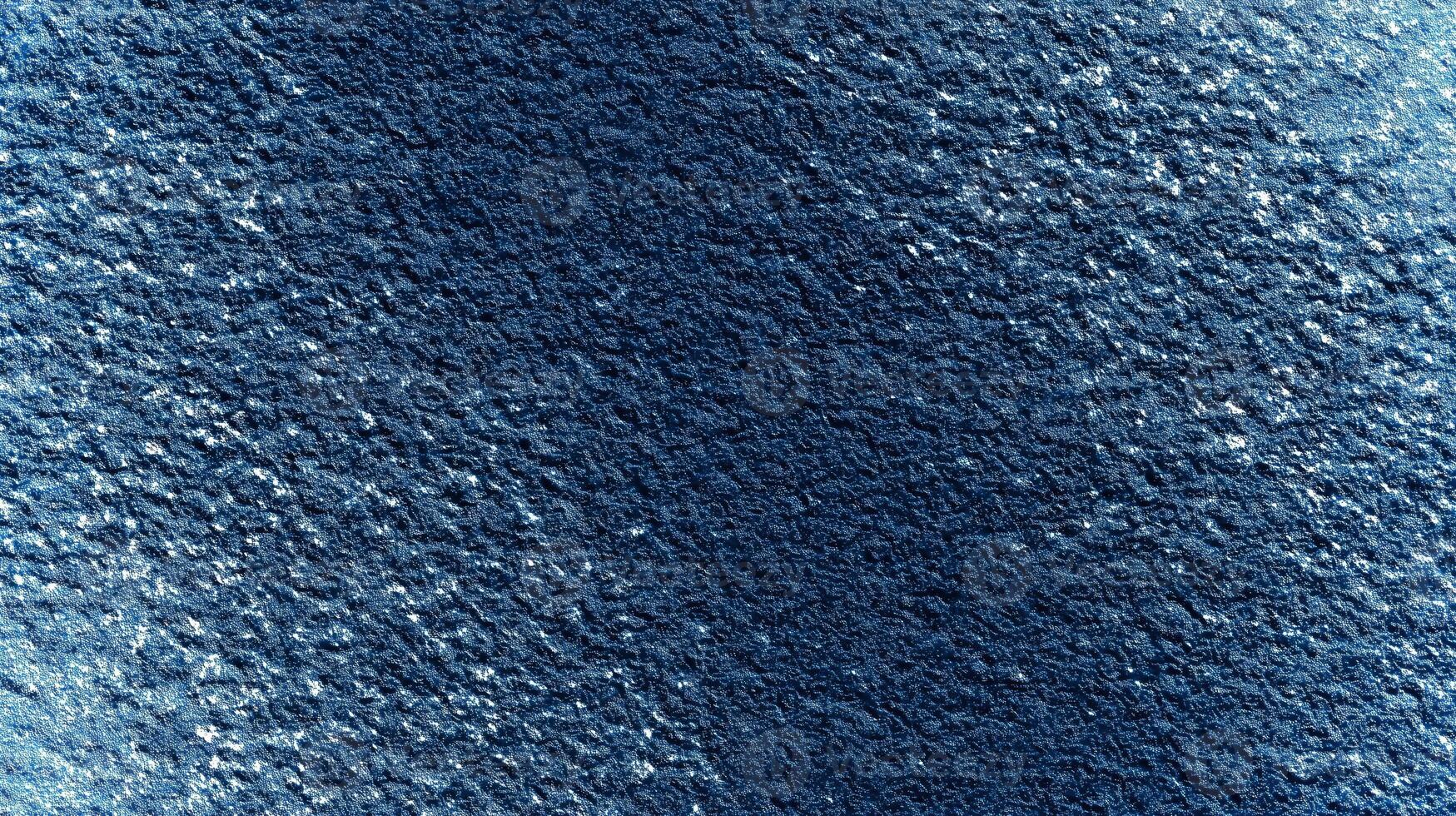 This deep blue textured surface offers a rich background ideal for eco-themed mockups, providing ample empty space for creative text placement and design elements. photo