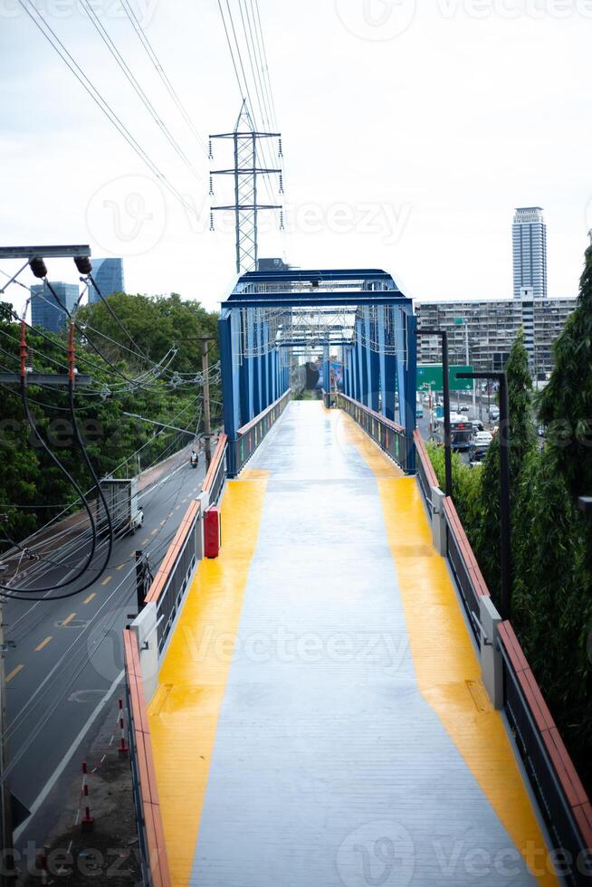 A bicycle overpass cycling skywalk bridge running through the middle of the city center photo