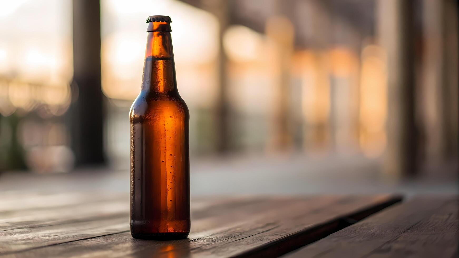 Brown Bottle Standing on Wooden Table at Sunset photo