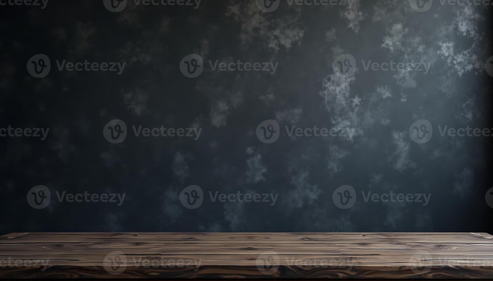 Empty wooden table in front of dark wall photo