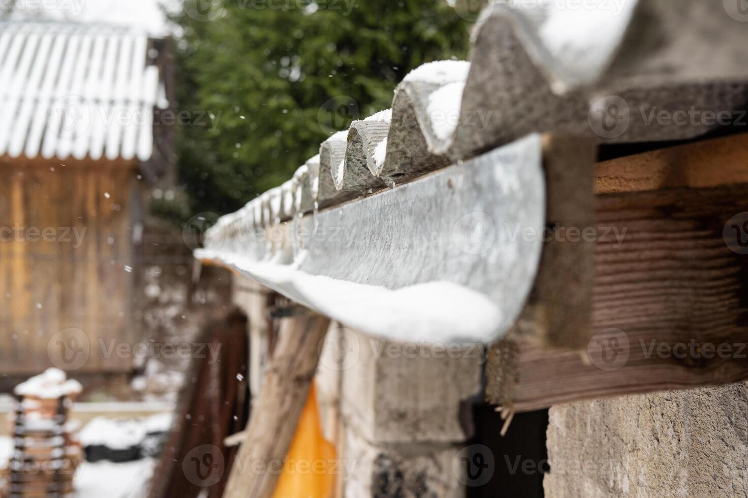 Rural snow-covered roofs in a winter landscape photo