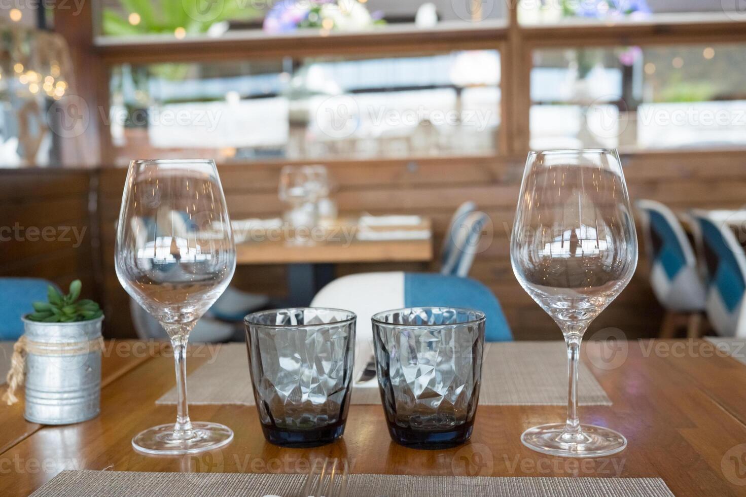 Elegant table setting with wine and water glasses in stylish restaurant photo