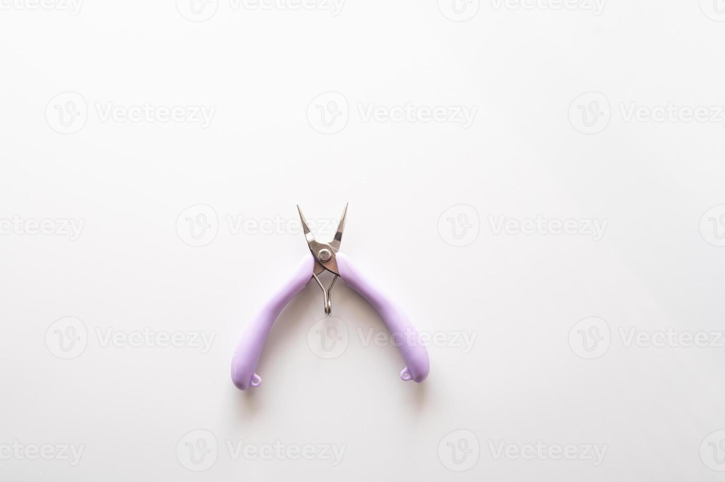 Purple handheld pliers on white background photo