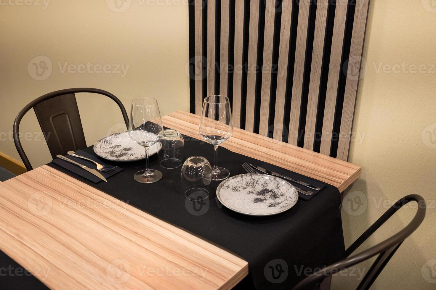 Elegant table setting with black and white plates in modern restaurant photo
