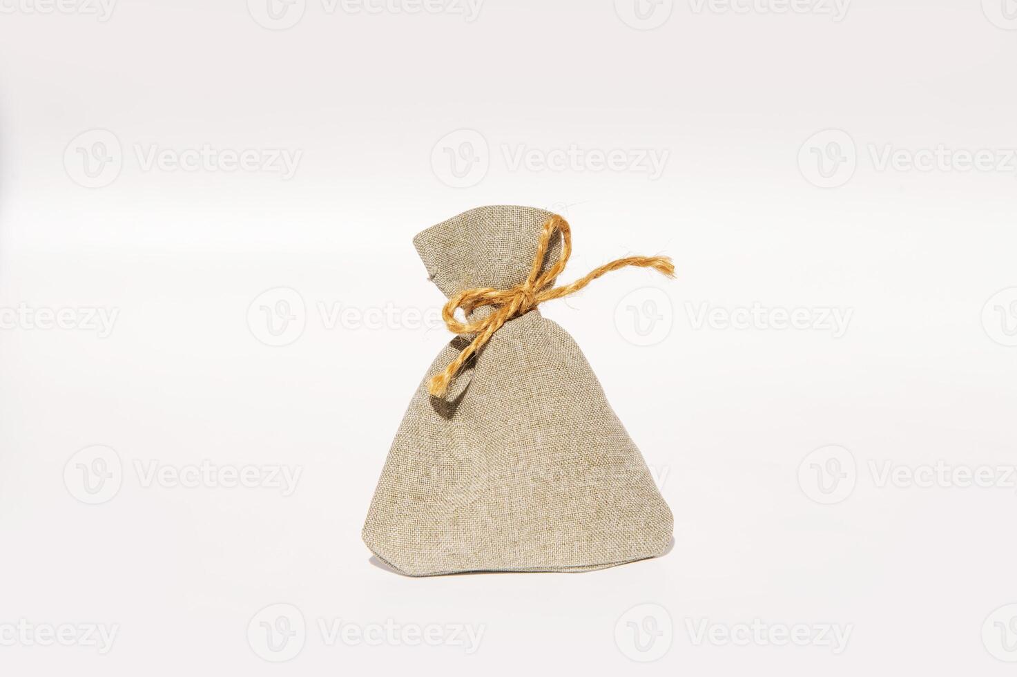 Simple beige burlap sack with twine against plain background photo