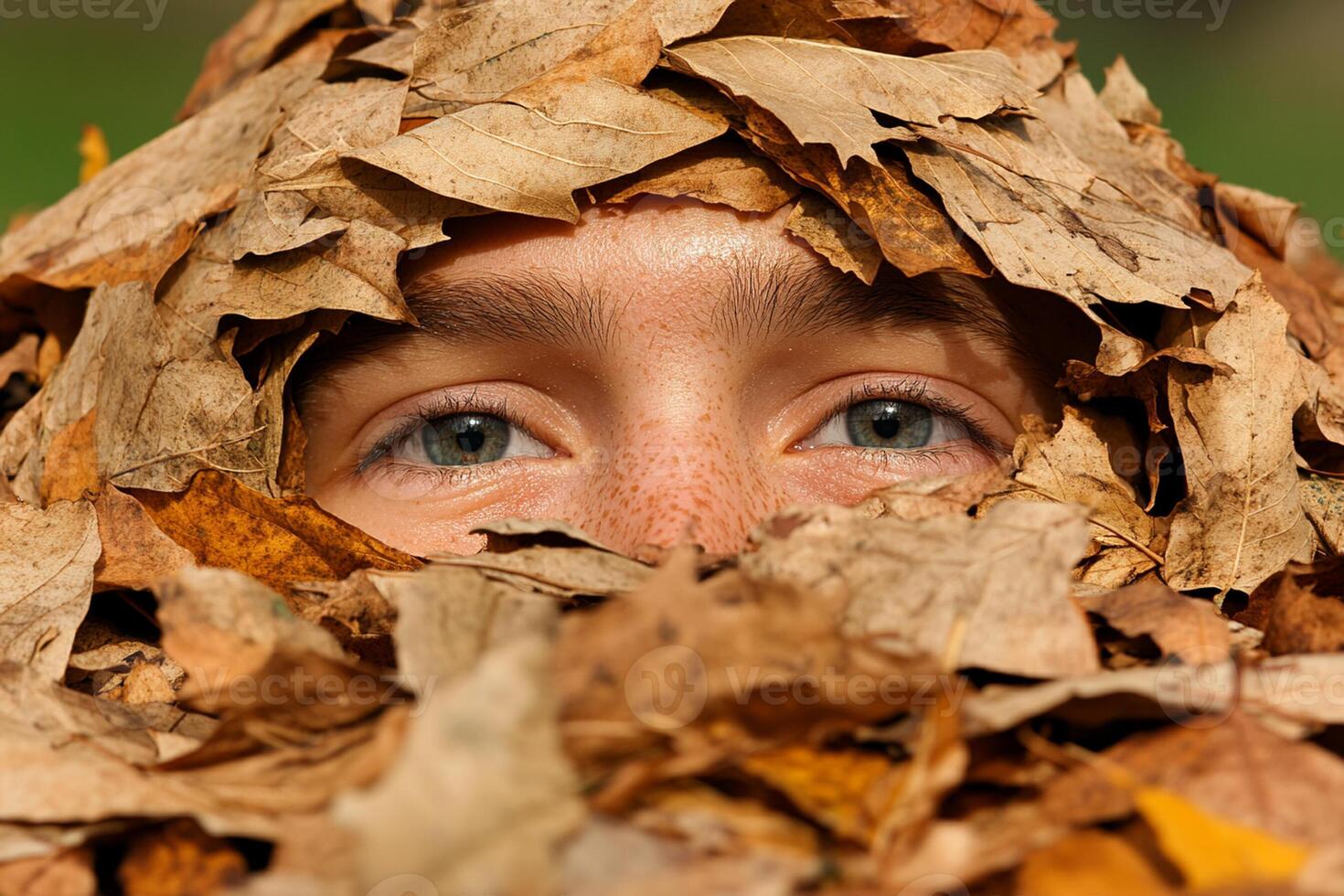 A person covered in leaves photo