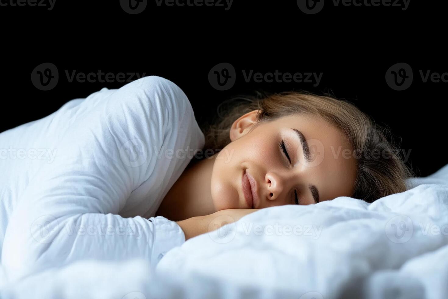 A woman is sleeping in bed with her eyes closed photo