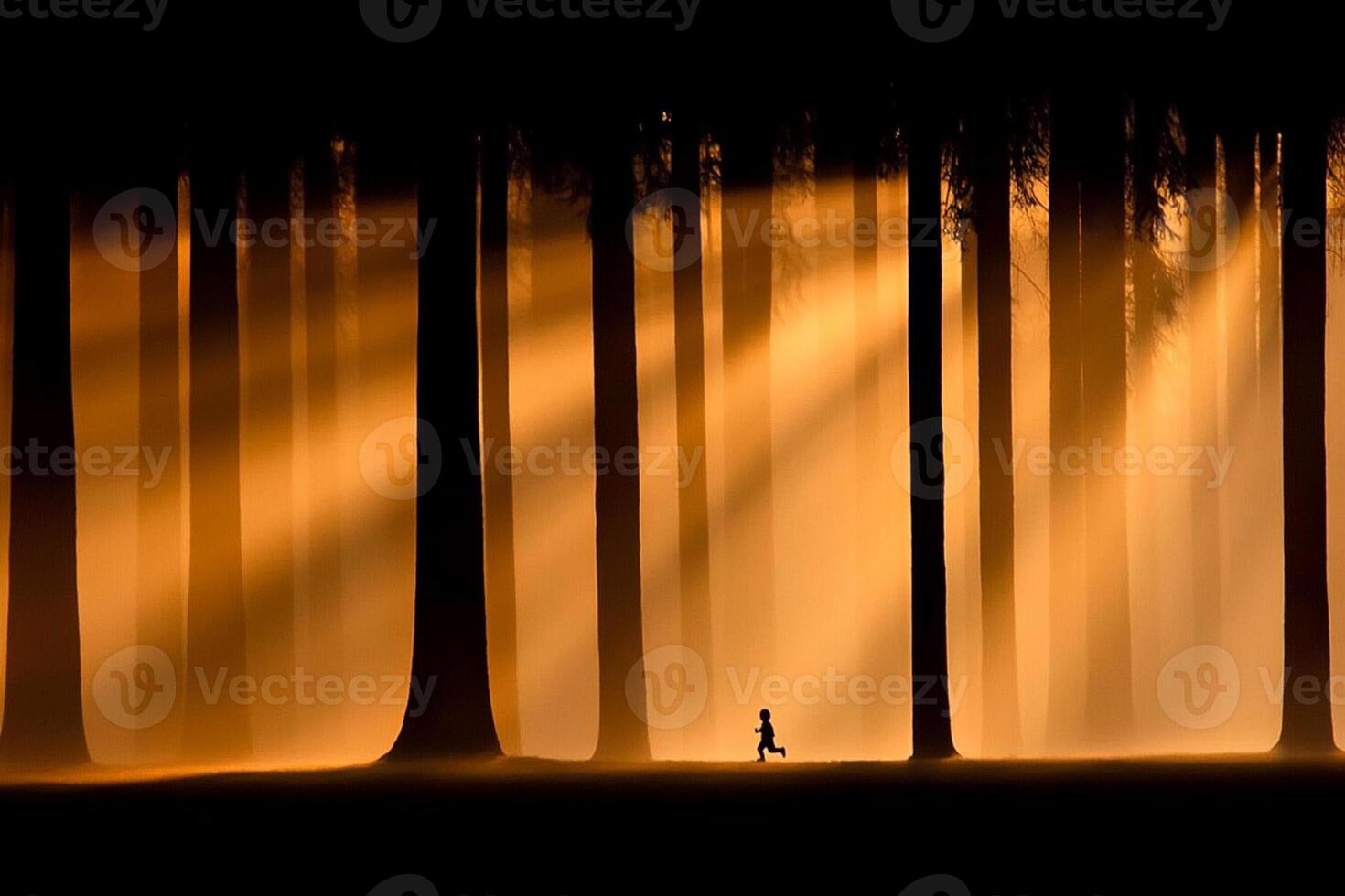 A lone person walking through a forest with sun beams coming from the trees photo