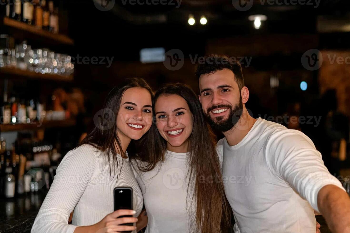 Three friends posing for a photo at a bar