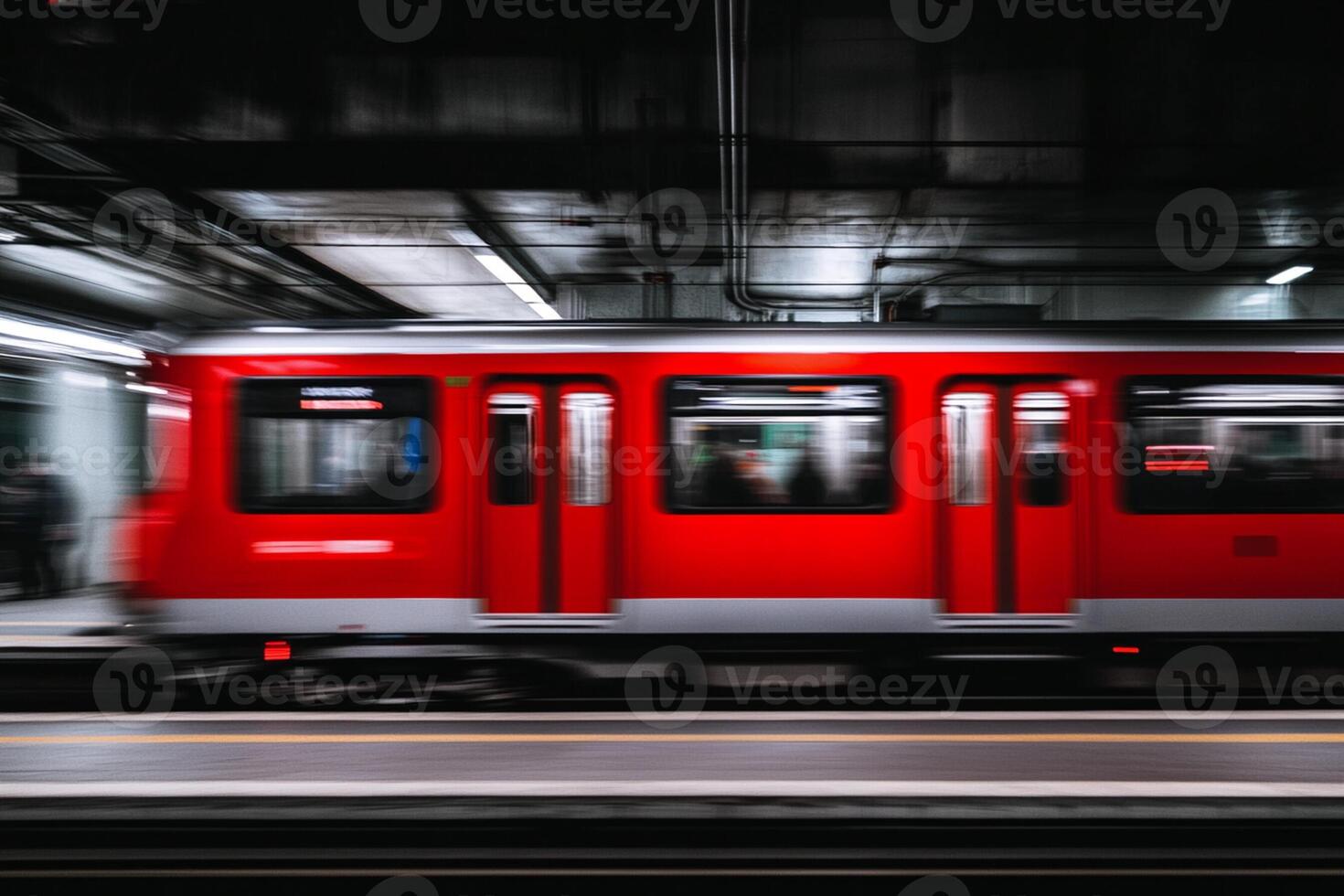 A red train moving through a subway station photo