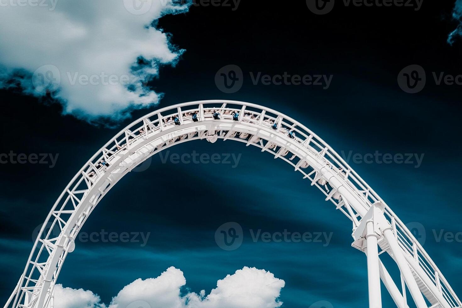 A roller coaster ride in front of a cloudy sky photo