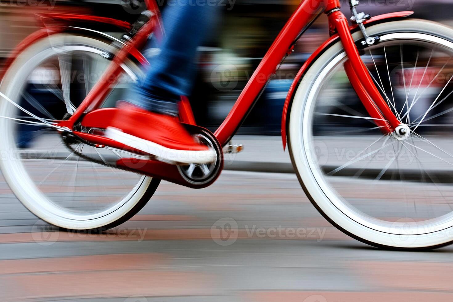 A person riding a red bike with white wheels photo