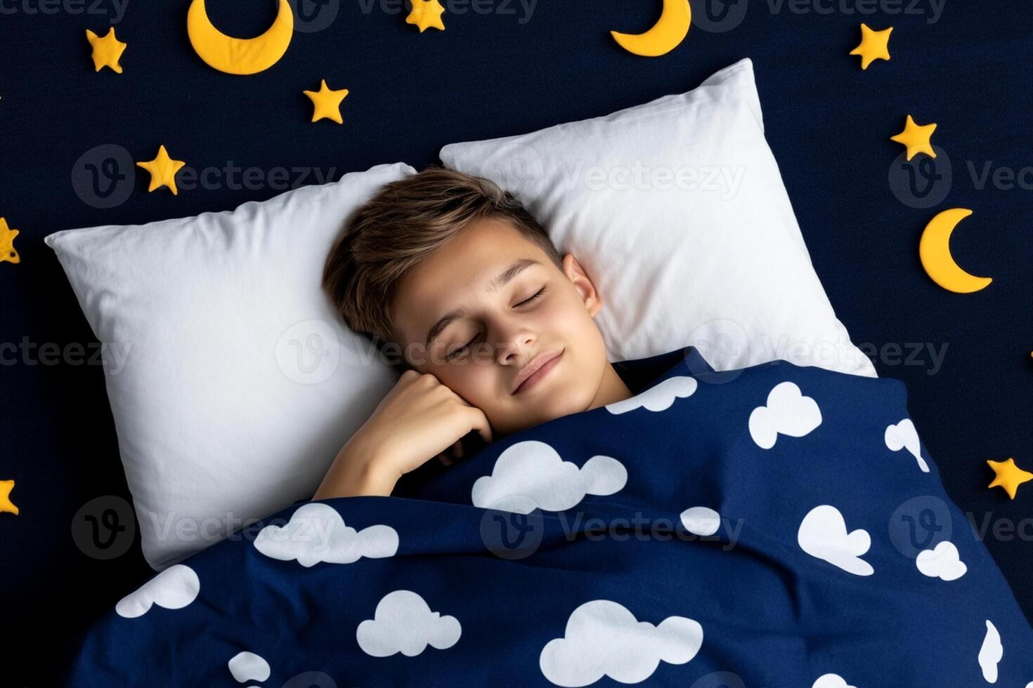 A boy sleeping in bed with clouds and stars photo