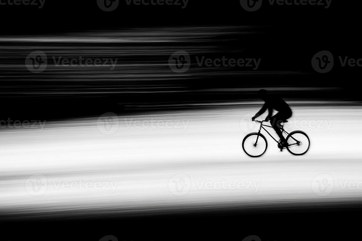 A person riding a bike in a black and white photo