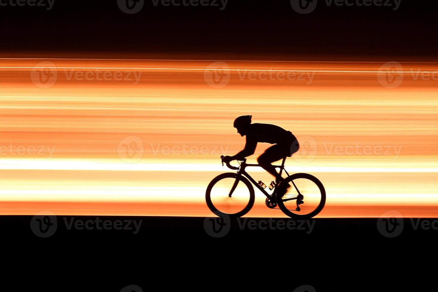 A cyclist is silhouetted against the sunset photo