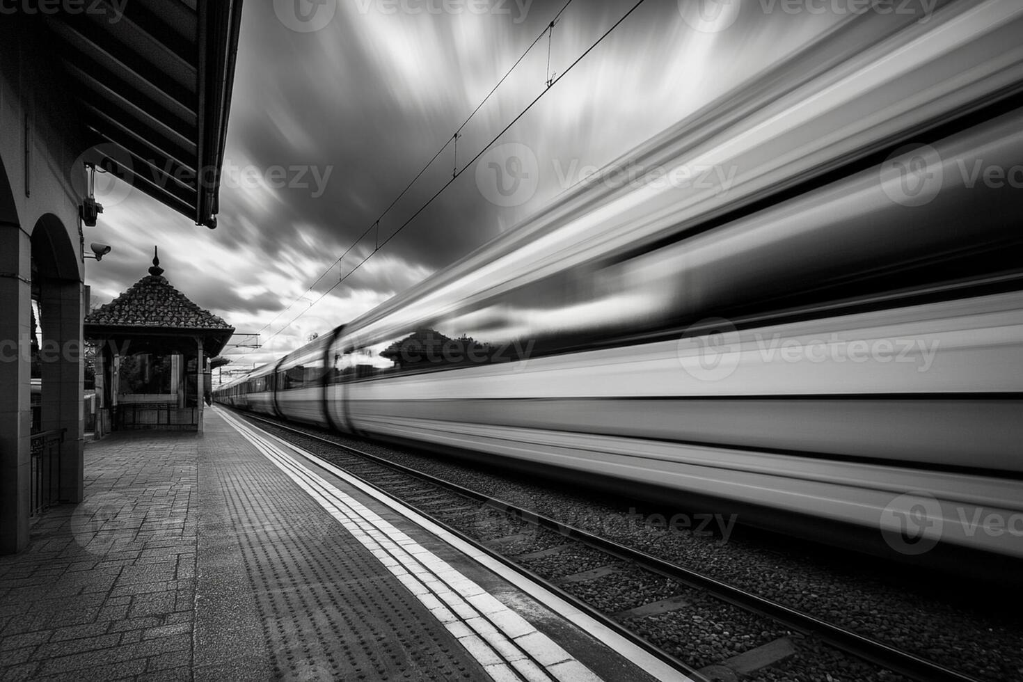 Black and white photograph of a train speeding by photo
