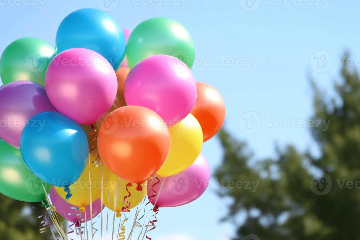 A bunch of balloons with a blue sky in the background photo