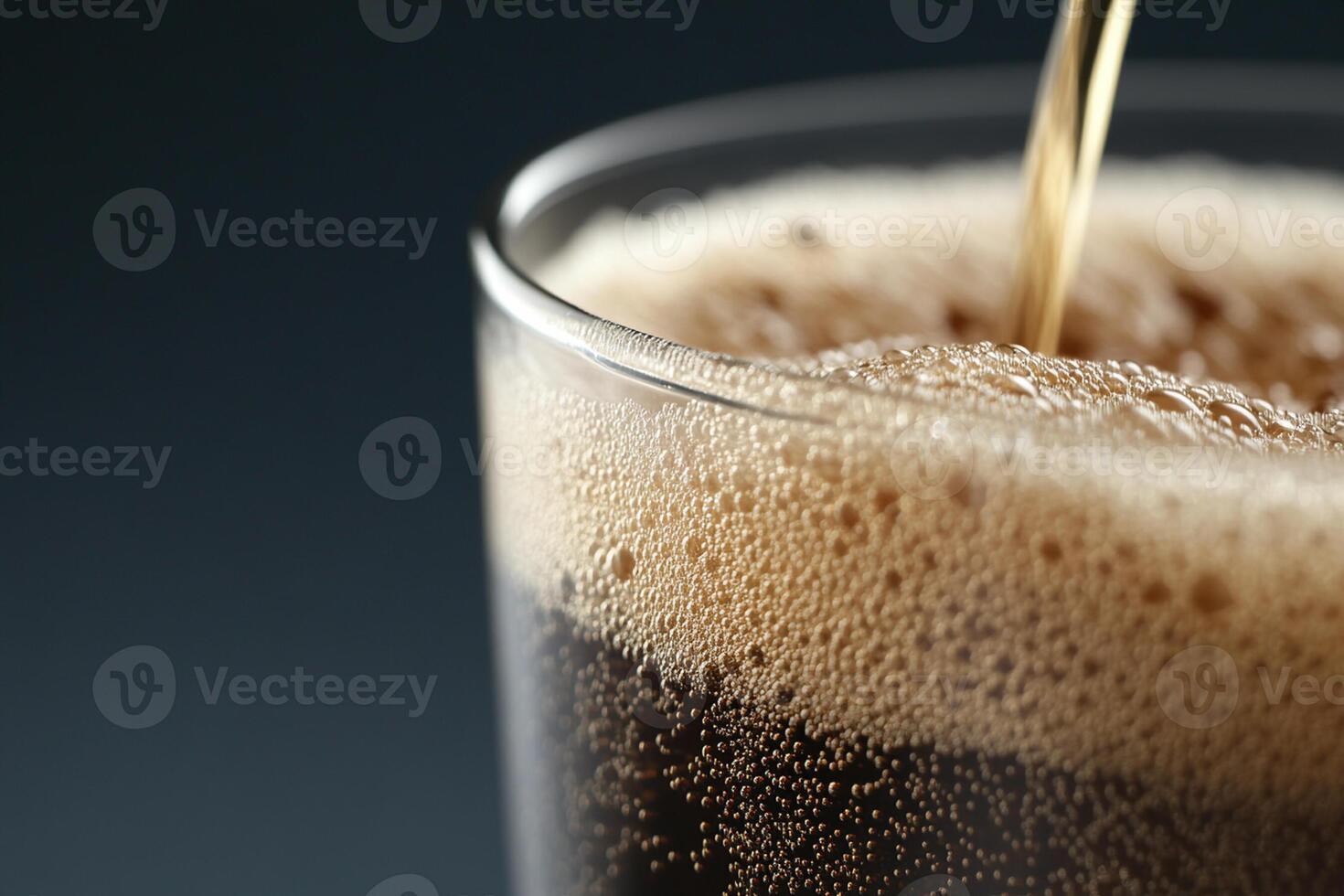 A glass of soda being poured into it photo