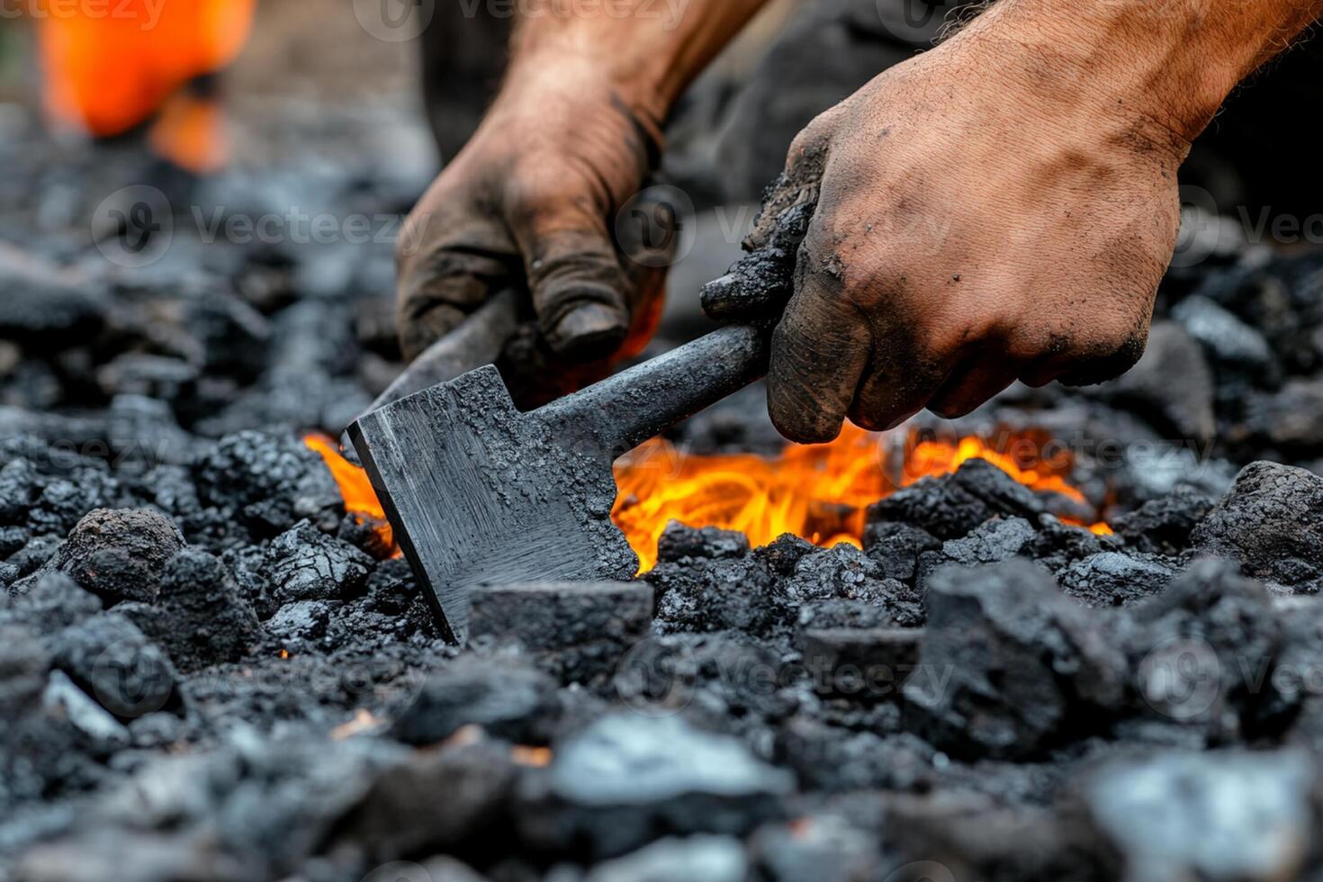 A person is using an axe to cut coal photo