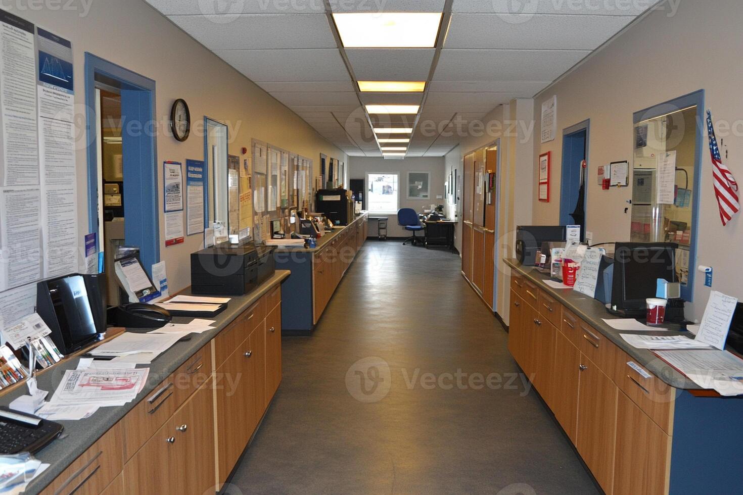 A long hallway with a lot of computers and papers photo