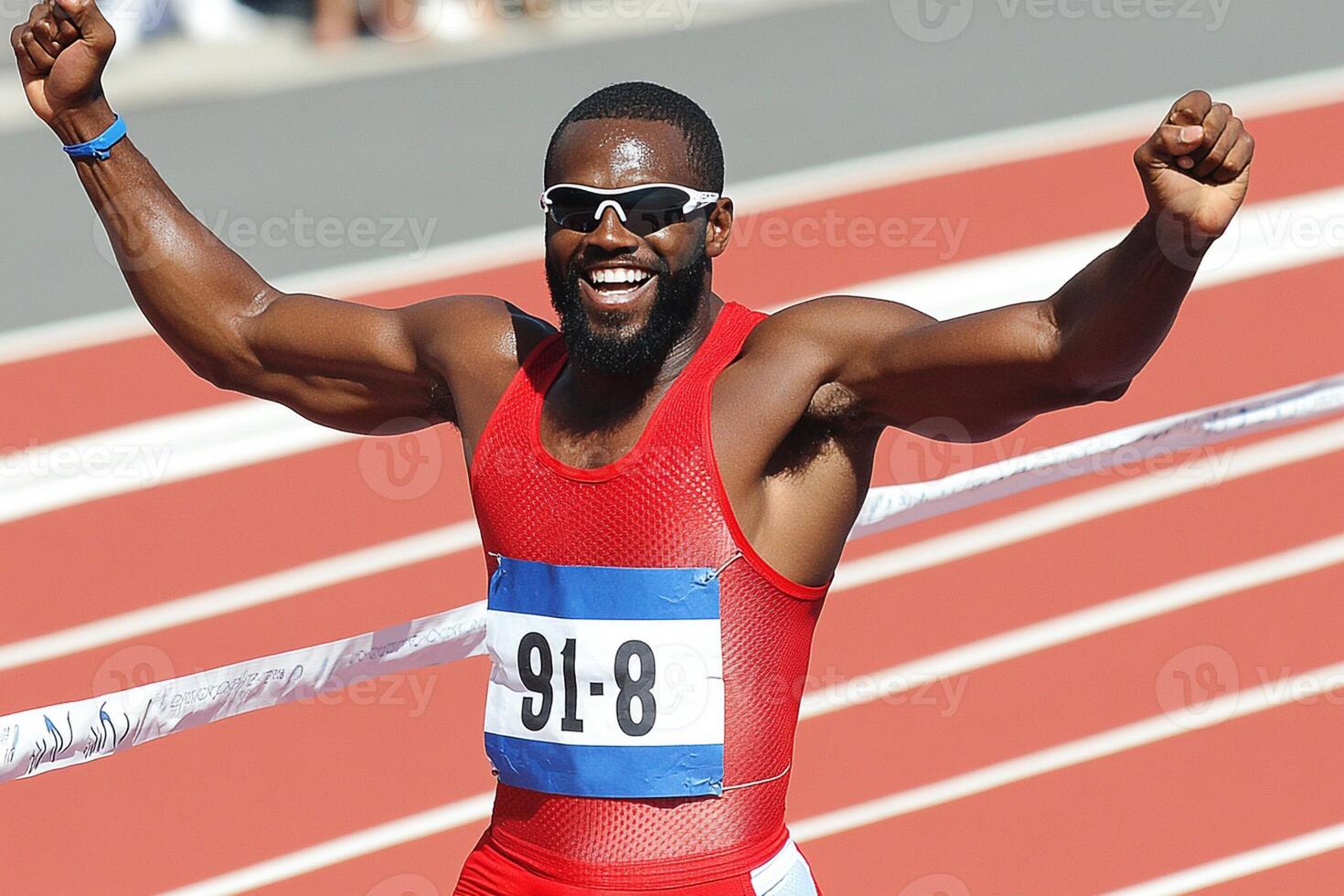 A man with a beard and sunglasses is celebrating on a track photo