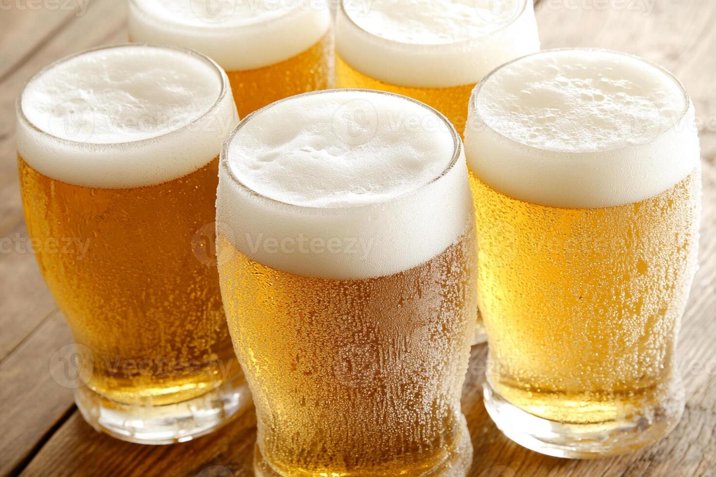 Five glasses of beer on a wooden table photo