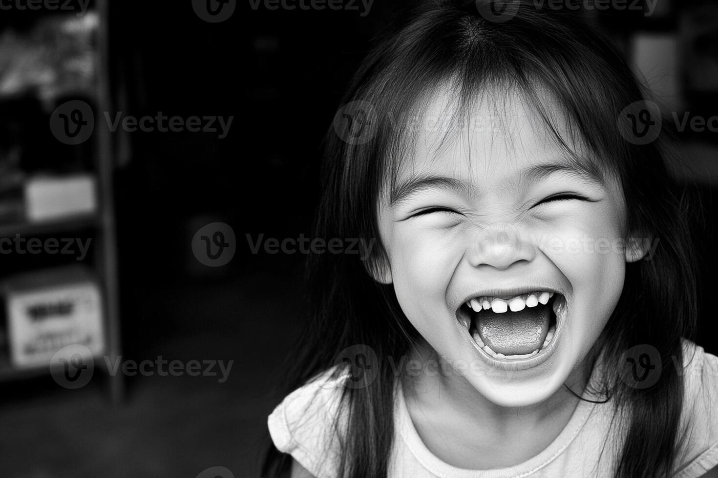 A little girl laughing in black and white photo