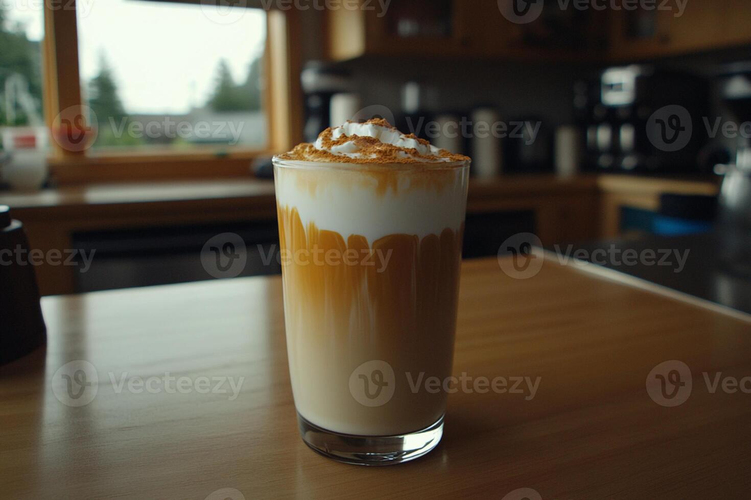 A drink with whipped cream and a coffee cup on a table photo