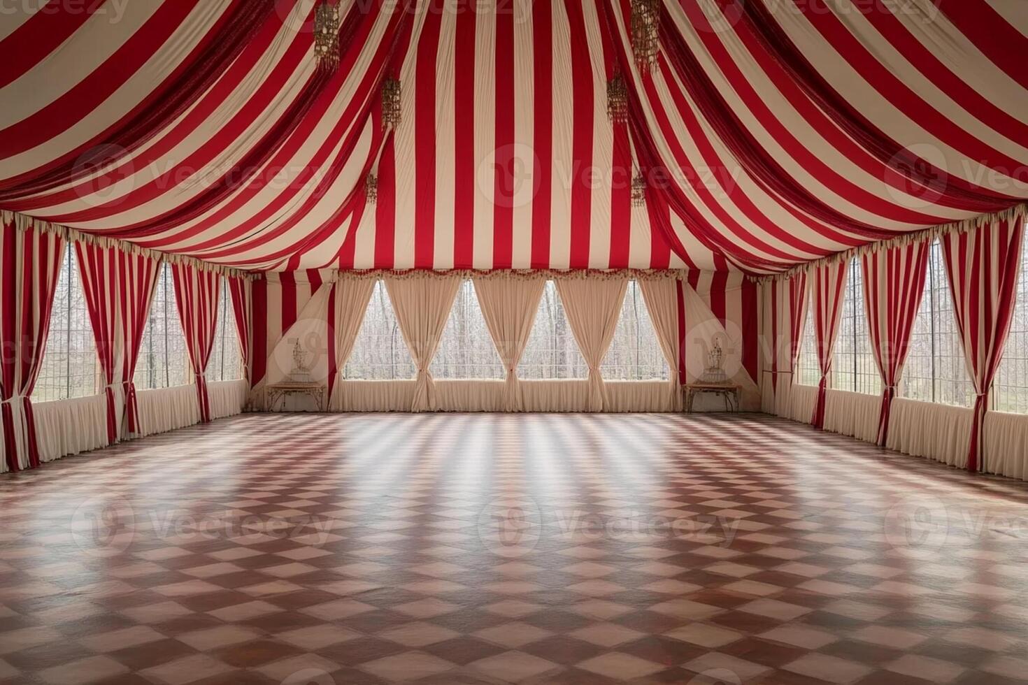 A large red and white striped tent with a checkered floor photo