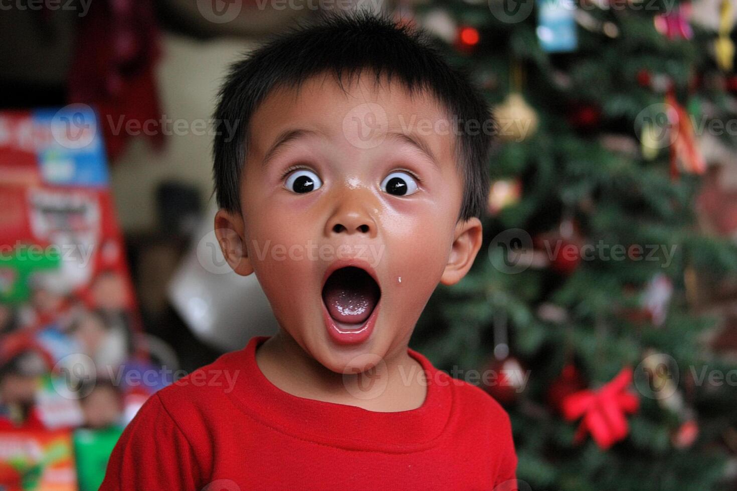 A young boy is surprised by a christmas tree photo