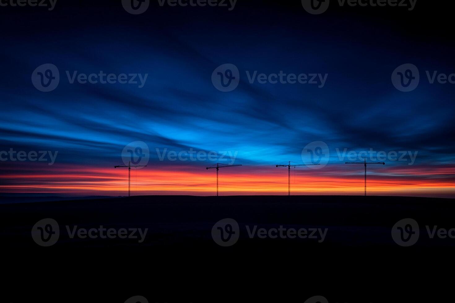 A sunset over the ocean with a few street lights photo