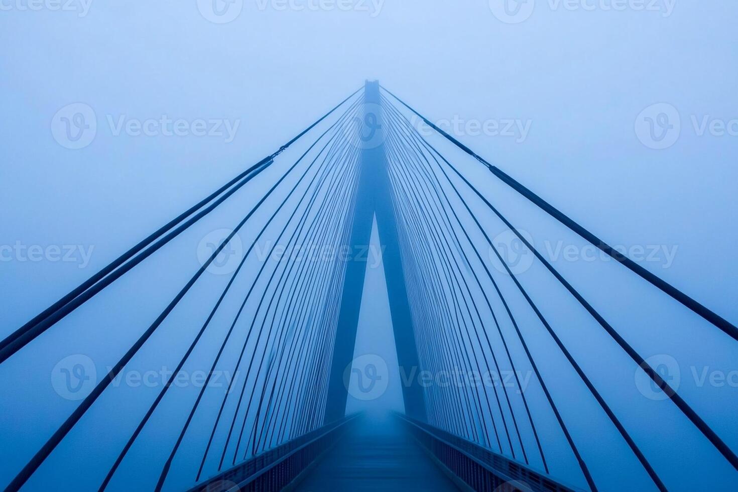 A bridge in the fog with a blue sky photo