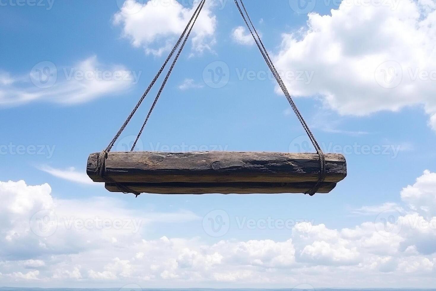 A wooden swing hanging from a rope over the ocean photo