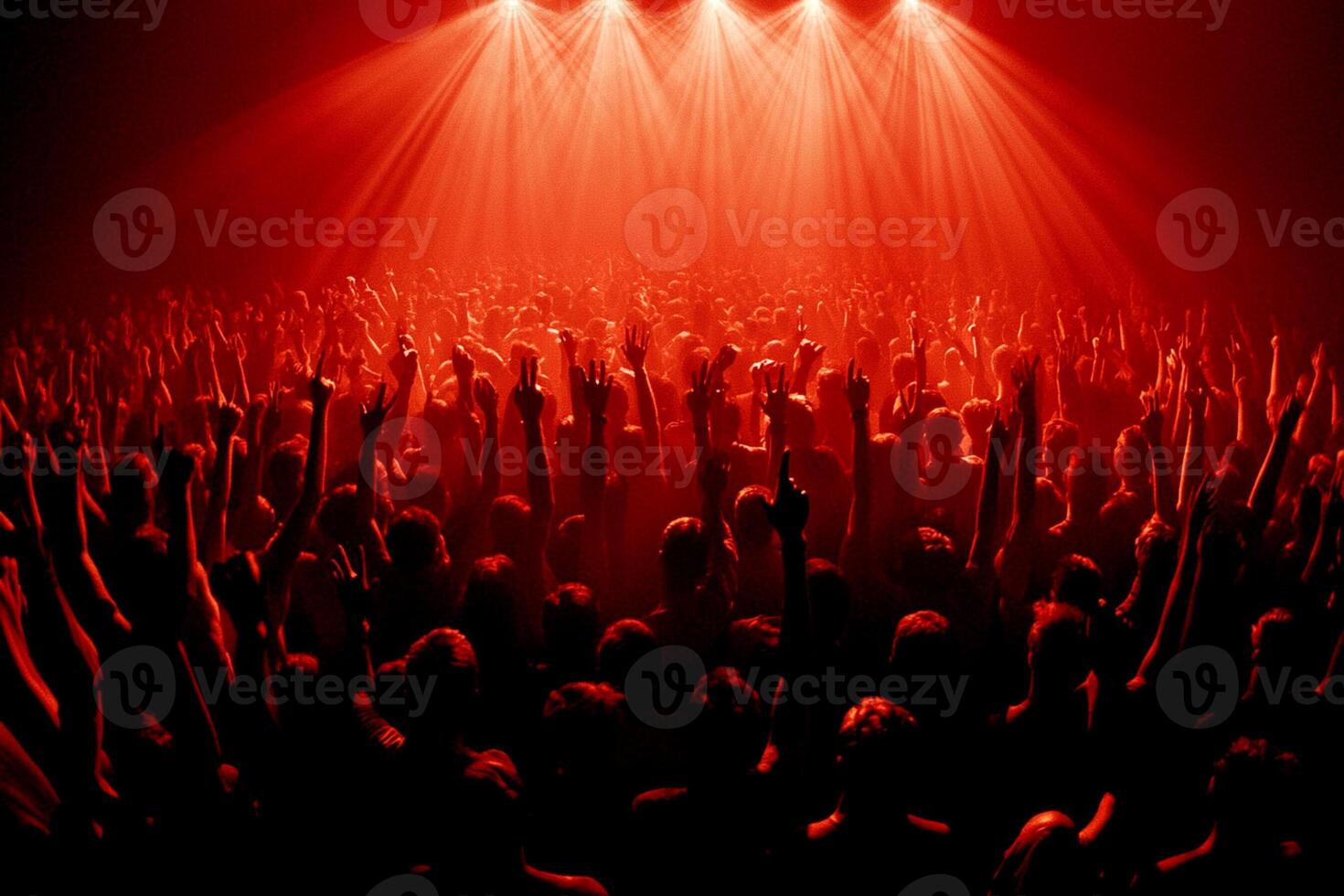 A crowd of people at a concert with red lights photo