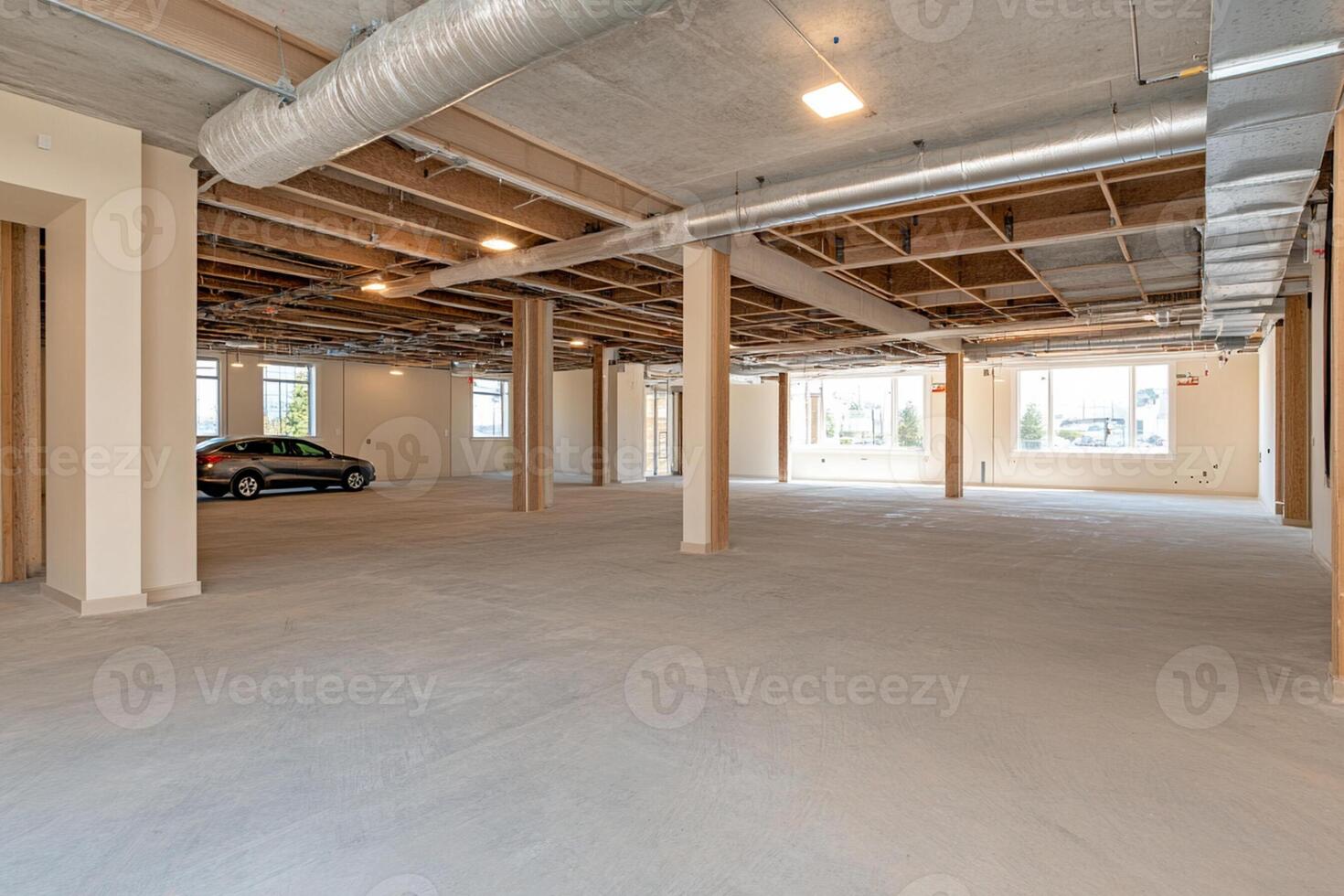 An empty room with a car parked in the middle photo