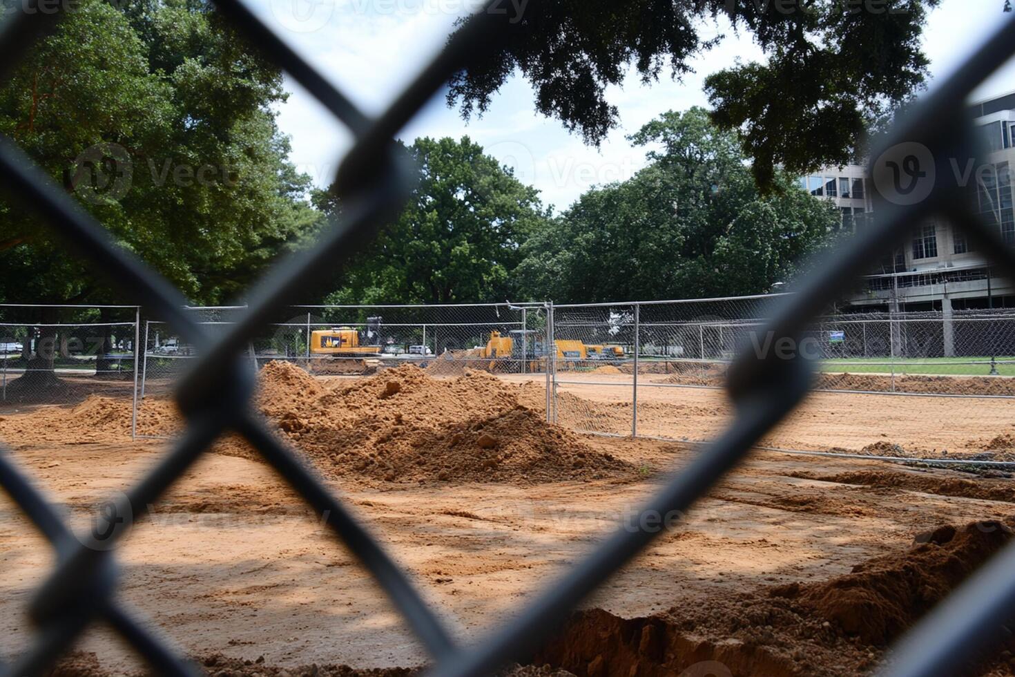 A construction site is seen through a chain link fence photo
