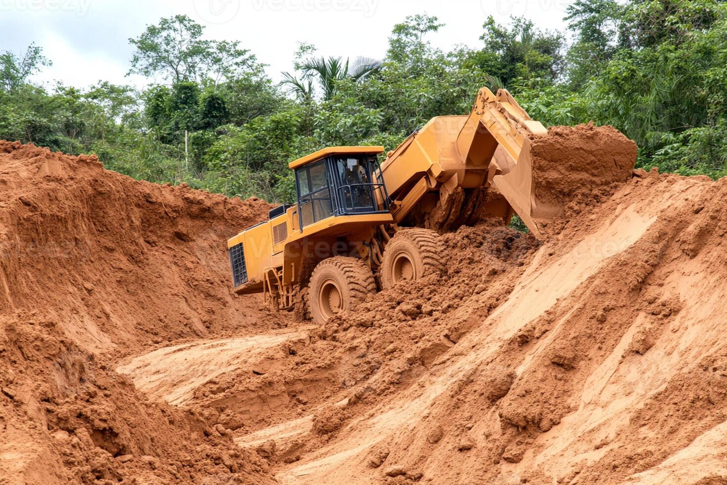 A large bulldozer is digging into the dirt photo