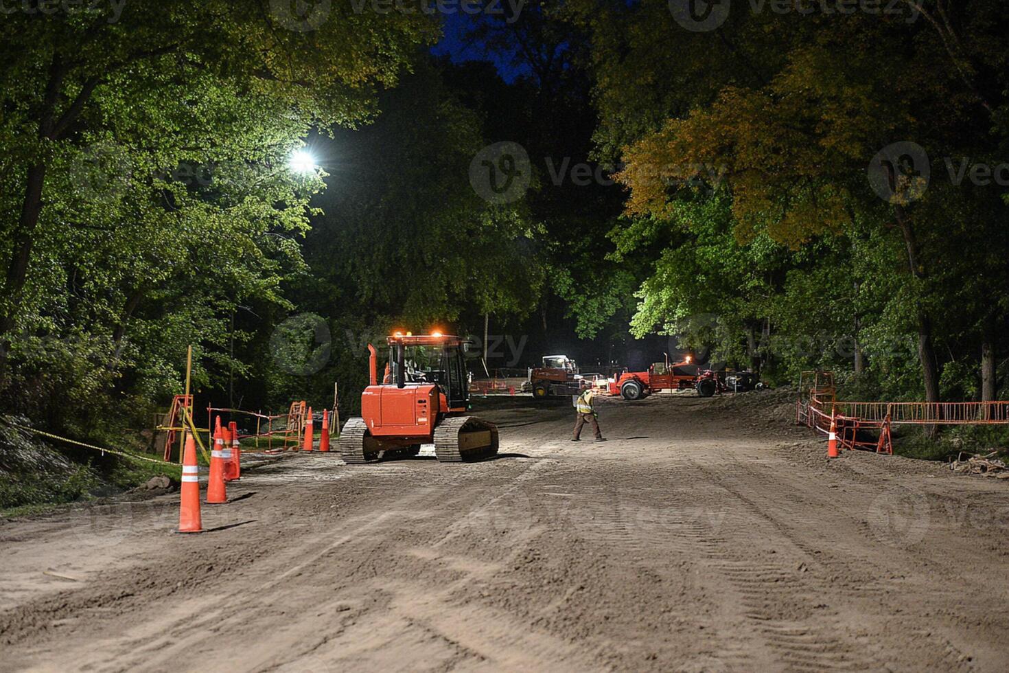 A construction crew working on a road at night photo