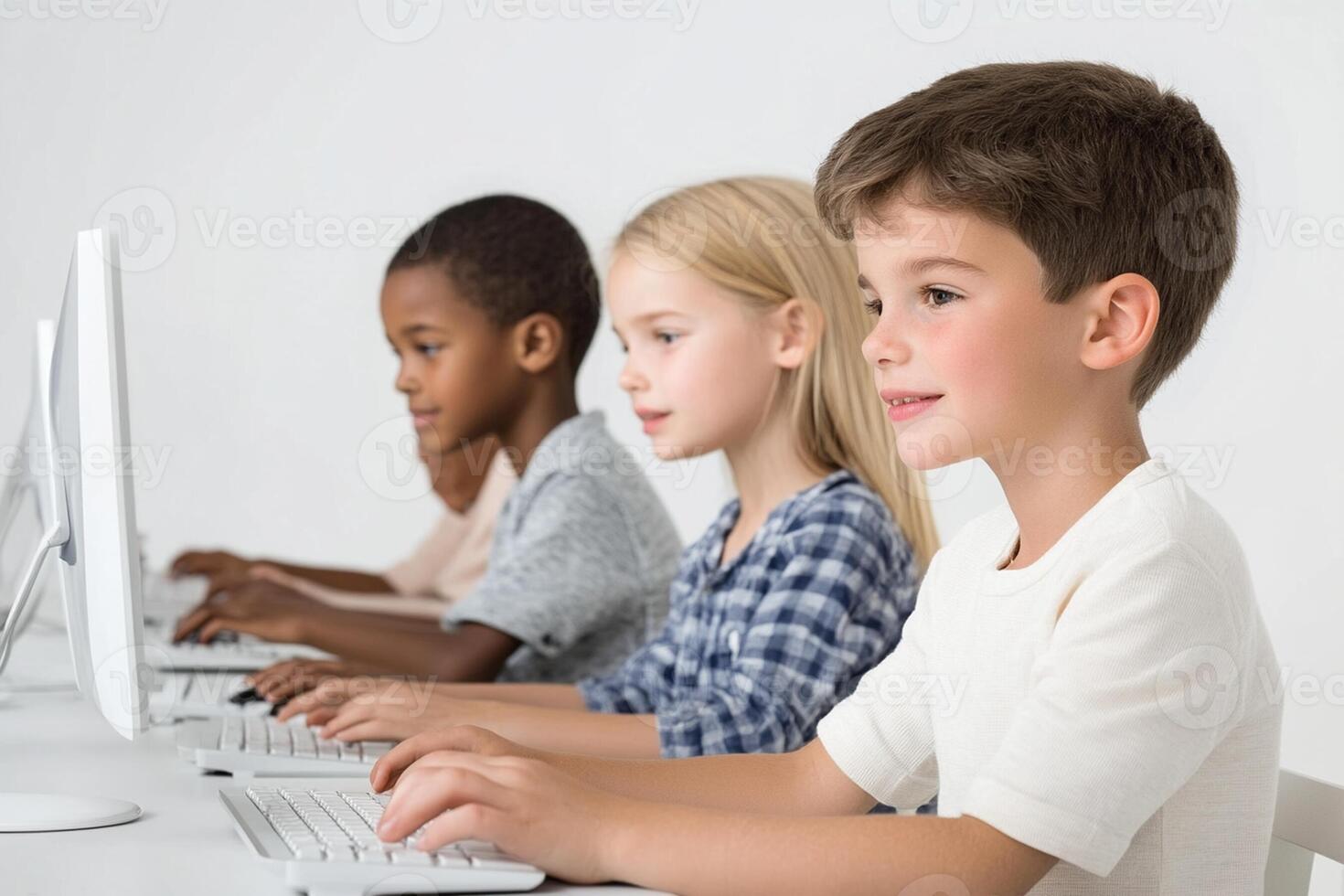 Children sitting at computers with one on each side photo