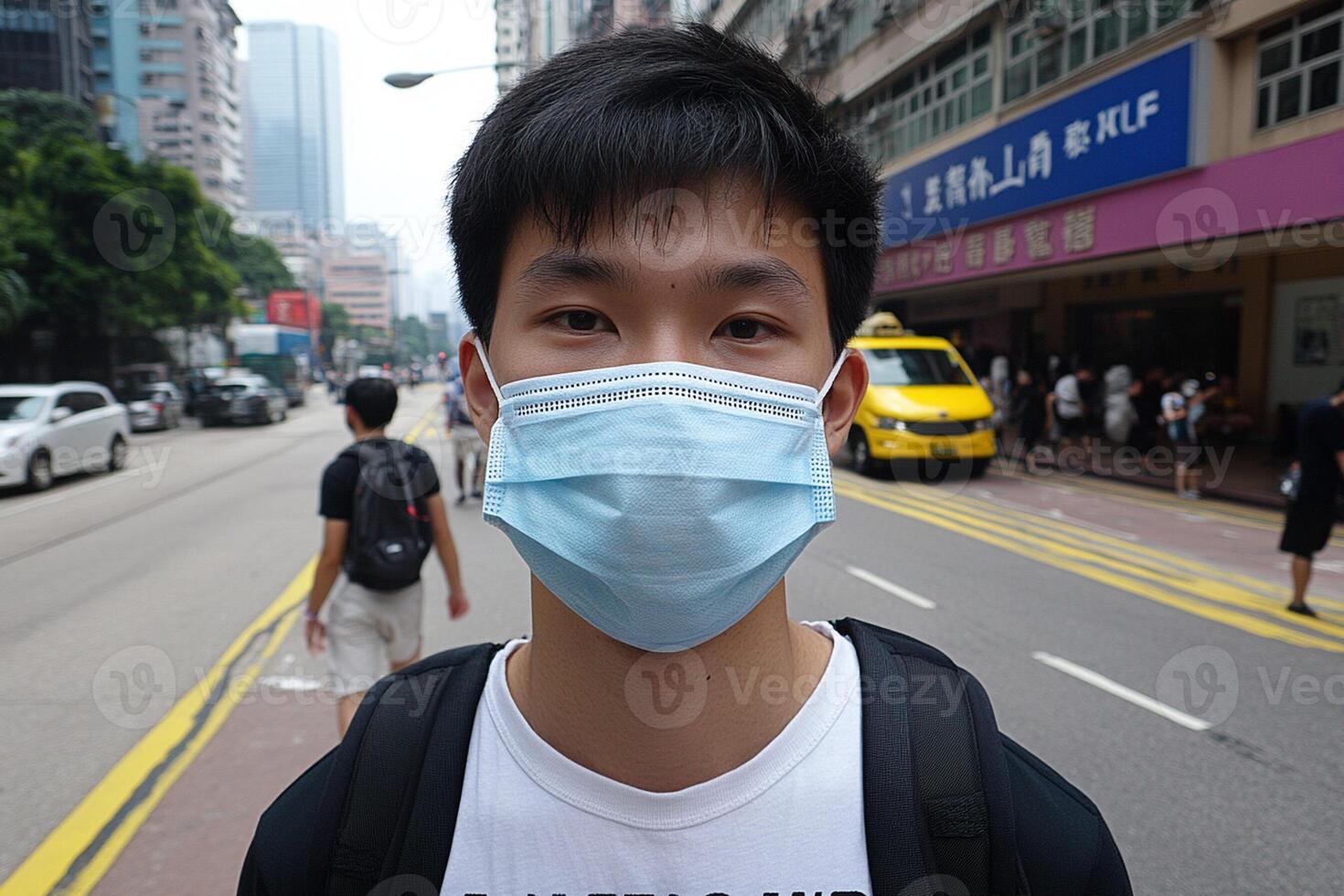 A man wearing a face mask on a city street photo