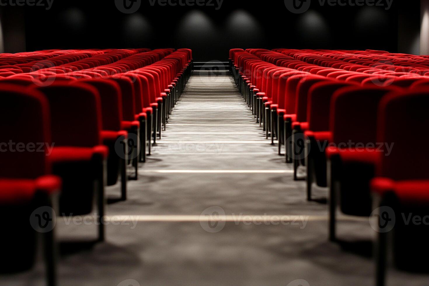 Rows of red chairs in an auditorium photo