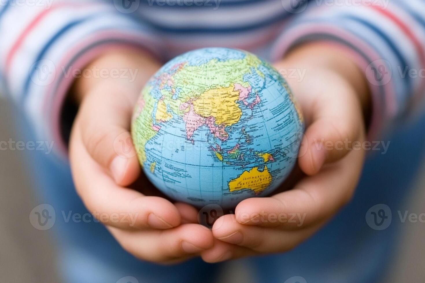Child holding a globe in his hands photo