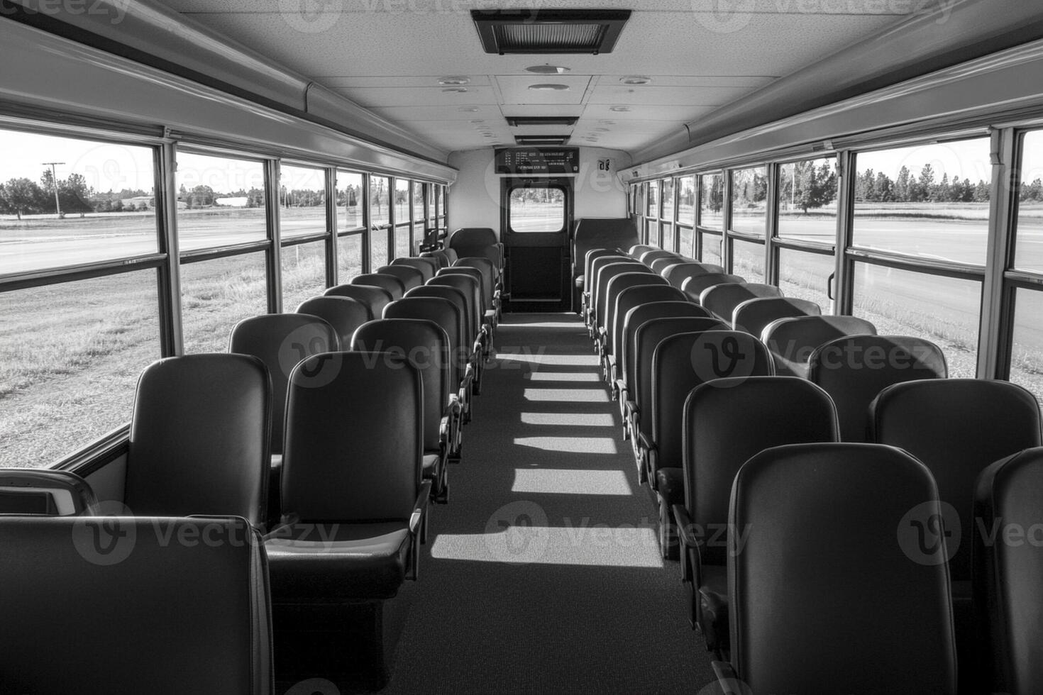 A black and white photo of empty seats on a bus