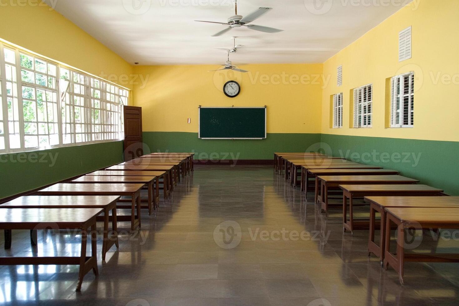 A classroom with desks and a blackboard photo