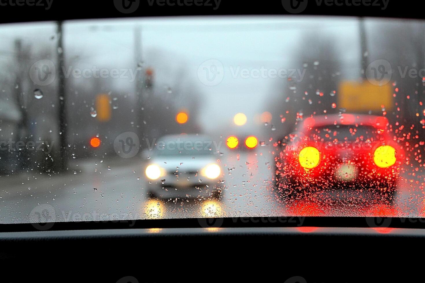 A car driving down the road in the rain photo
