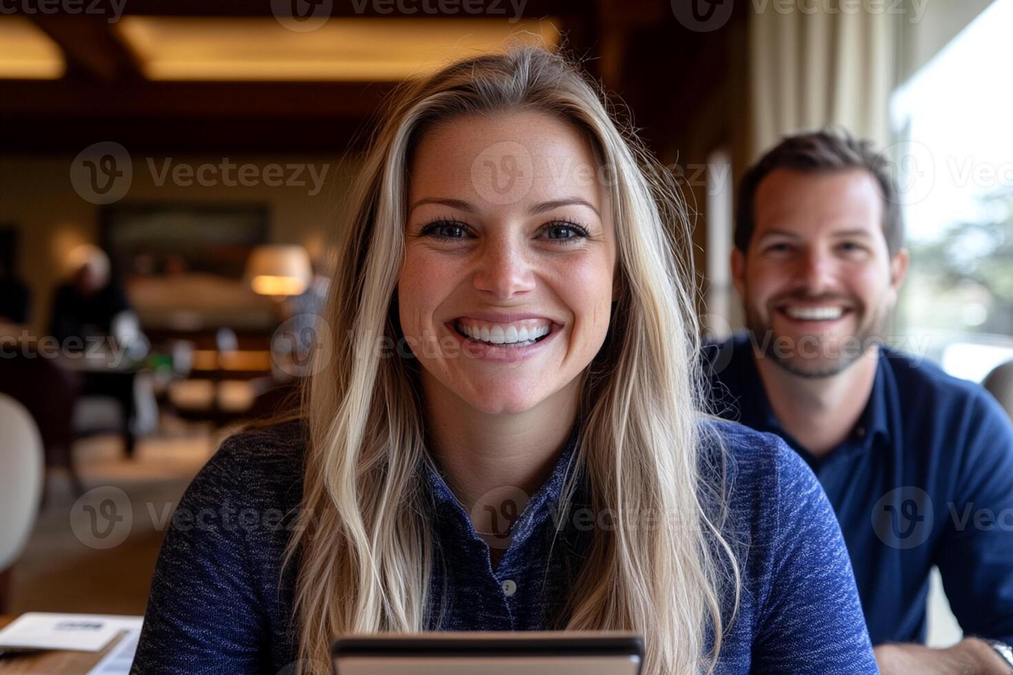 A man and woman smiling while sitting at a table photo