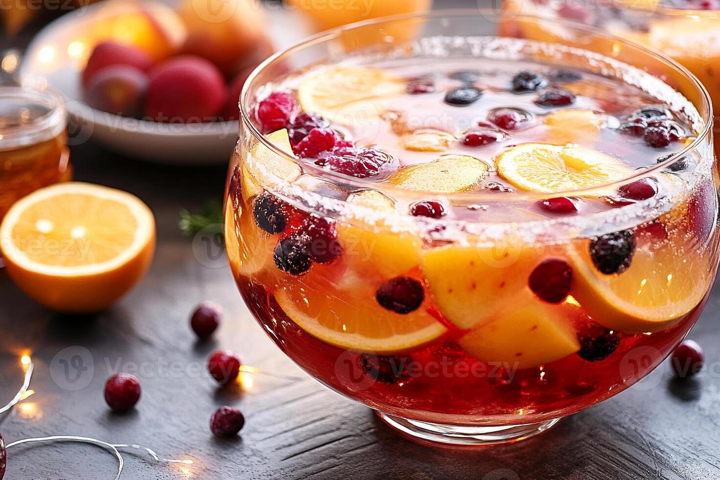 A bowl of fruit and orange juice with oranges and cranberries photo