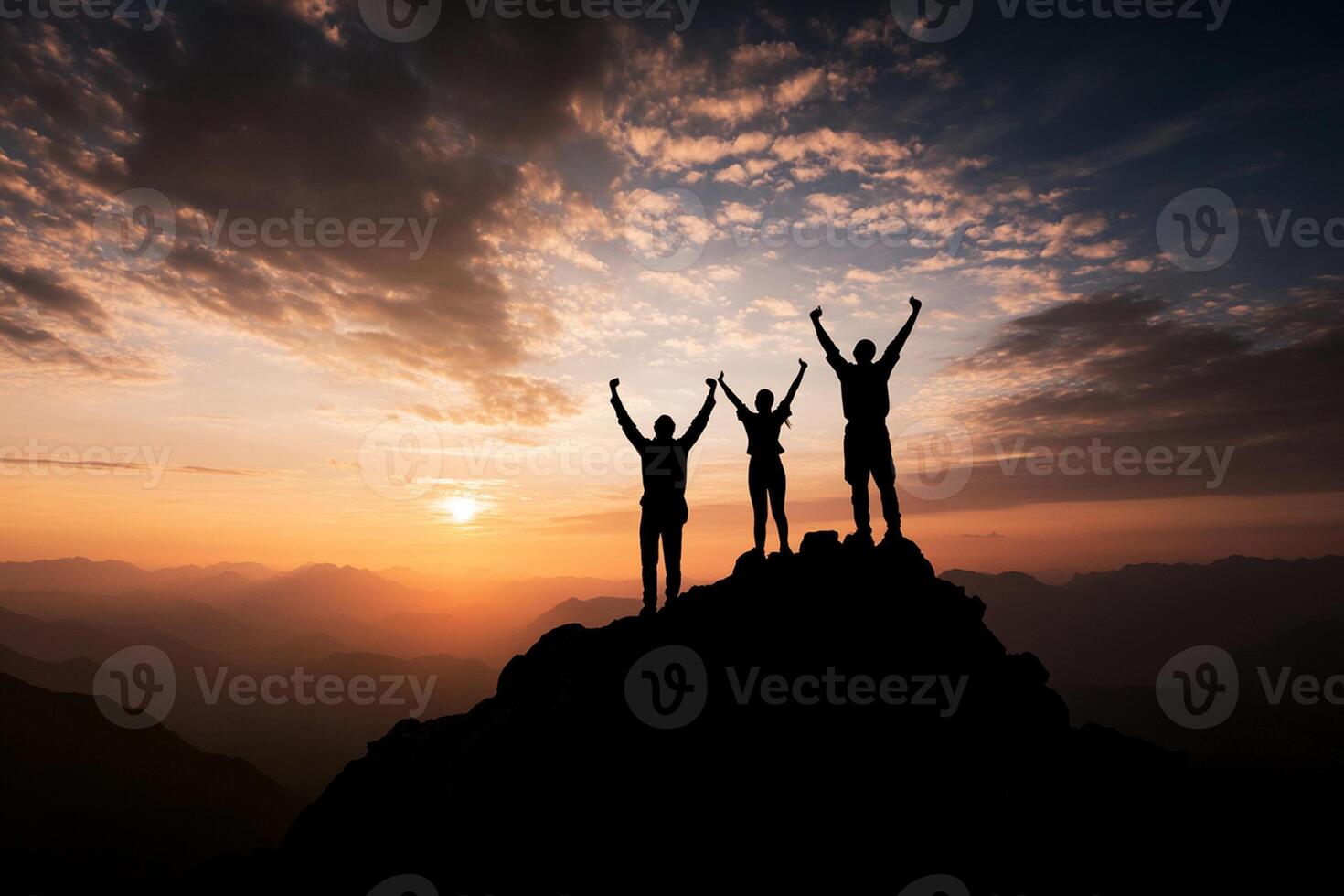 Silhouette of three people standing on top of a mountain at sunset photo