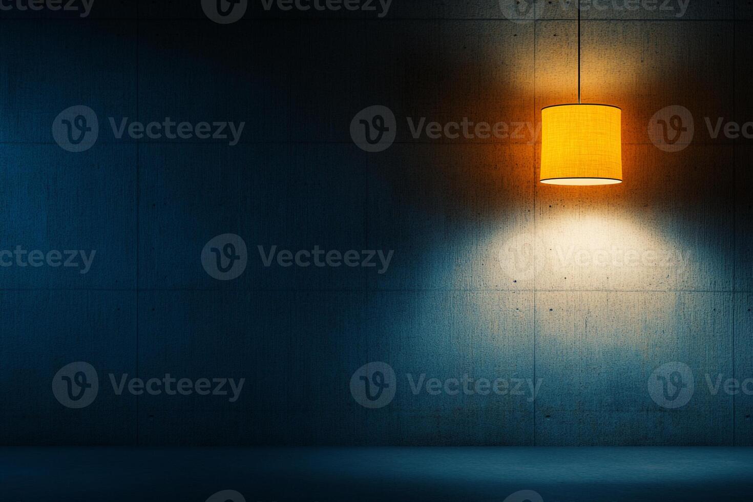 A yellow lamp is hanging from a ceiling in a dark room photo
